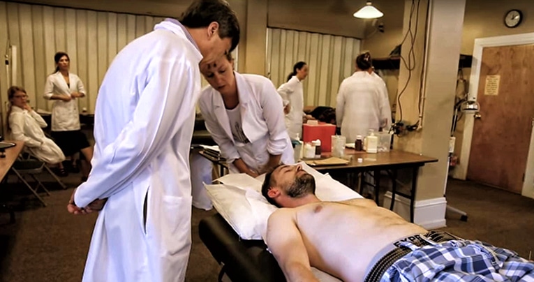 Picture of two students treating a patient in a CSTCM classroom